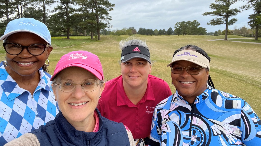 Four female golfers taking a group selfie during a round of golf in Houston Texas