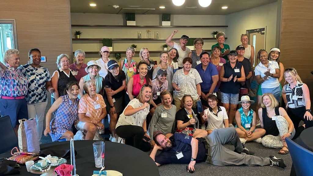 A group of female golfers taking a photo during a social event in Houston Texas