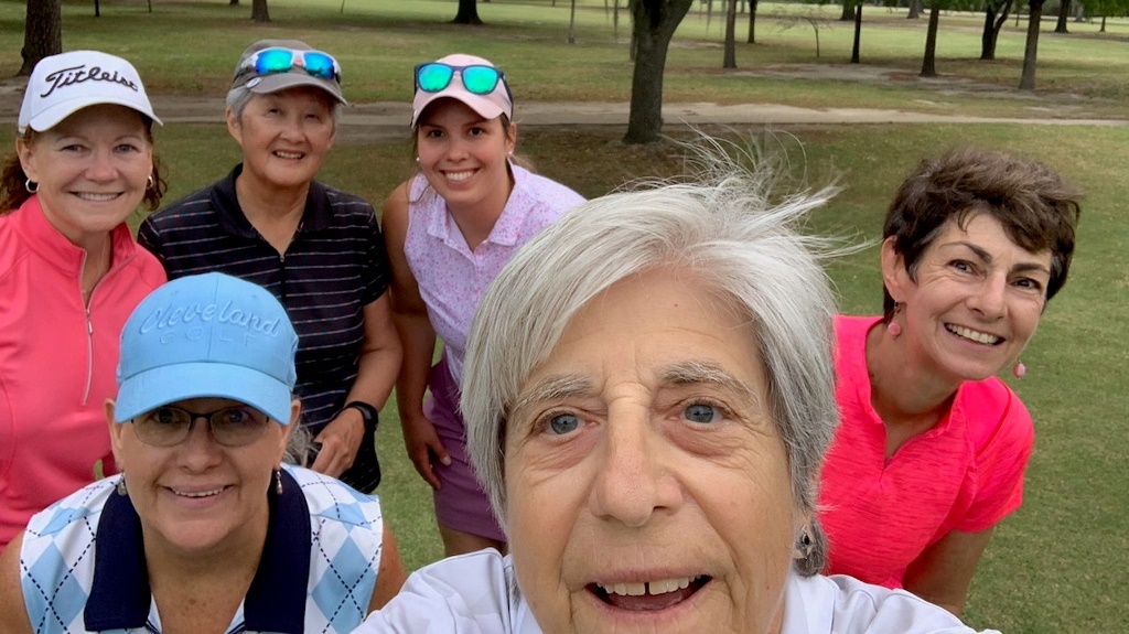 A group of female golfers posing for a selfie during a round of golf at Hermann Park in Houston Texas