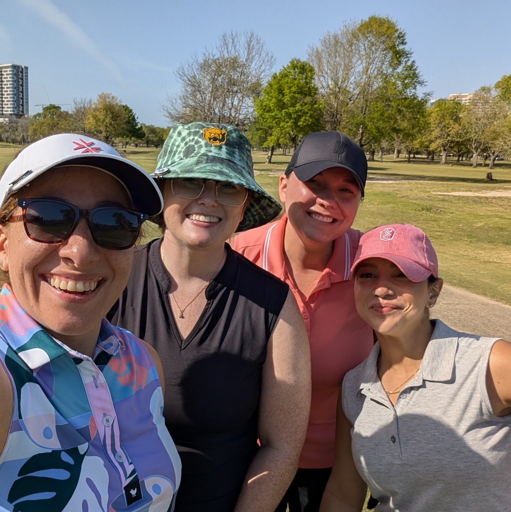 Four female golfers taking a selfie during a round of golf in Houston Texas