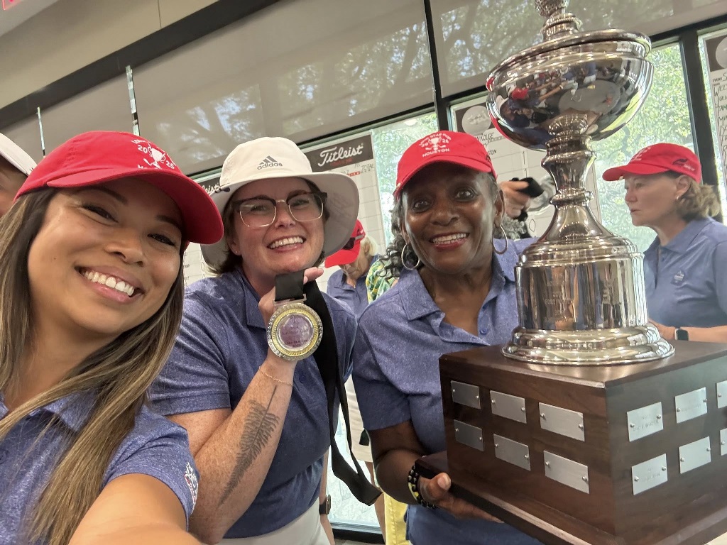 Four female golfers celebrating their win at a golf tournament in Texas. Lone Star Cup.