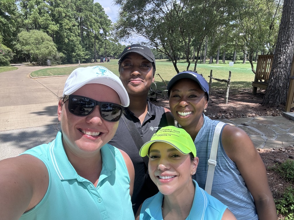 Four female golfers posing for a selfie during a round of golf in Houston Texas