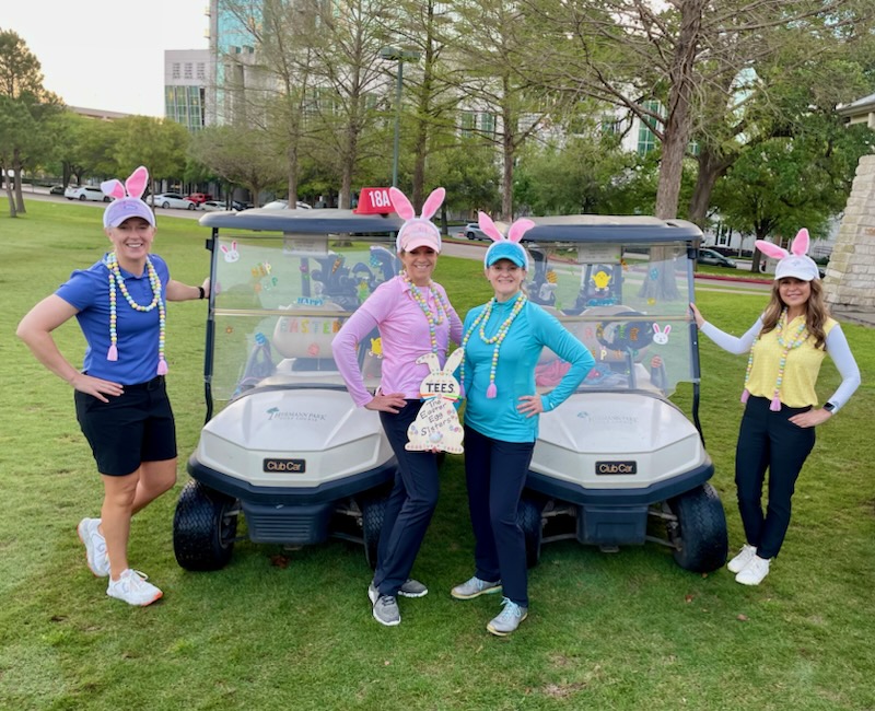 A group of female golfers dressed in bunny ears posing for a picture during a round of golf in Houston Texas