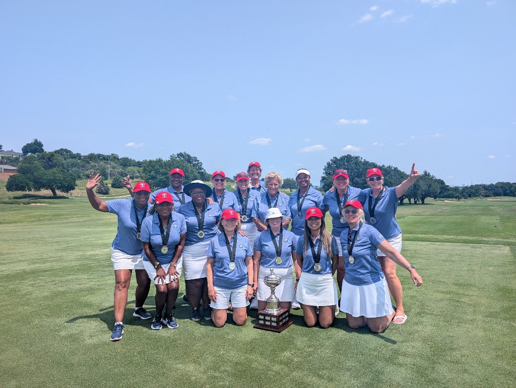 A team of female golfers celebrating their win of the Lone Star Cup for the Houston Texas team