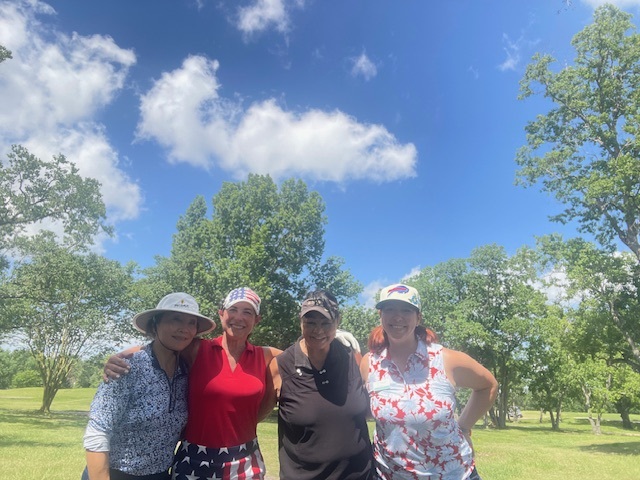 Four female golfers playing golf on a sunny day in Houston Texas
