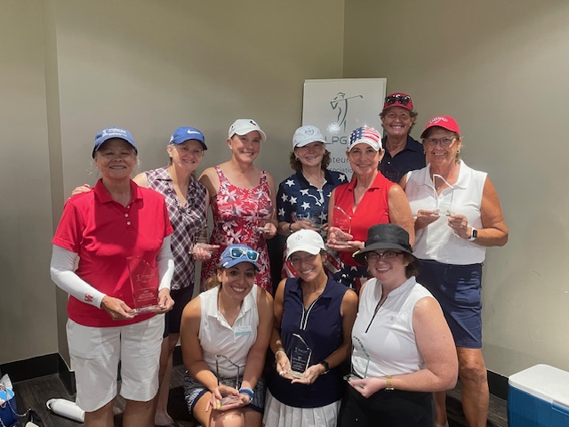 A group of female golfers celebrating their wins at a tournament in Houston Texas. They are wearing patriotic apparel