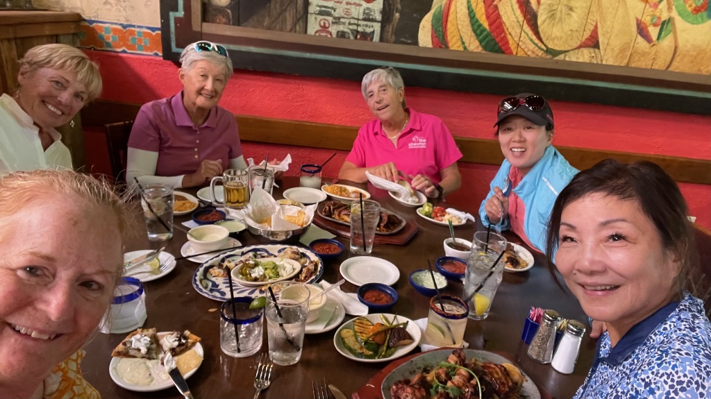 A group of female golfers gathering for a nice lunch after a round of golf in Houston Texas