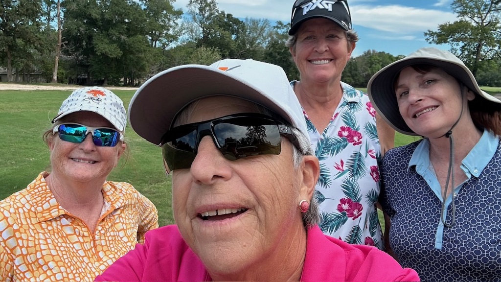 Four female golfers taking a selfie on the golf course in Houston Texas